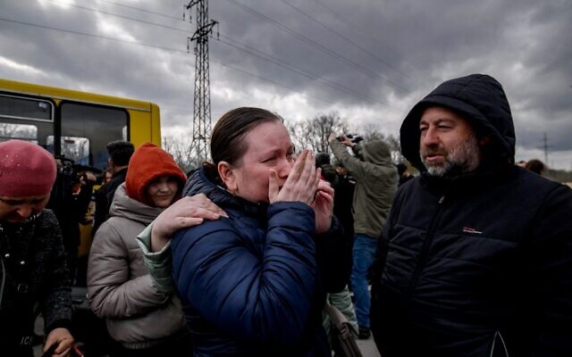 People fleeing fighting in the southern city of Mariupol meet with relatives and friends as they arrive in a small convoy after the opening of a humanitarian corridor, at a registration center for internally displaced people in Zaporizhzhia, on April 21, 2022. (Ed Jones/AFP)