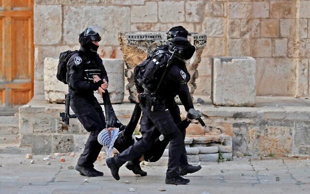 Illustrative: Israeli police arrest a Palestinian during clashes at the Temple Mount compound in Jerusalem's Old City on April 22, 2022. (Ahmad Gharabli/AFP)