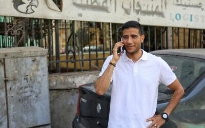 Egyptian journalist Mohamed Salah talks on the phone in Cairo following his release from the police station in al-Abassya district, on April 24, 2022. (Mohamed EL-RAAI / AFP)
