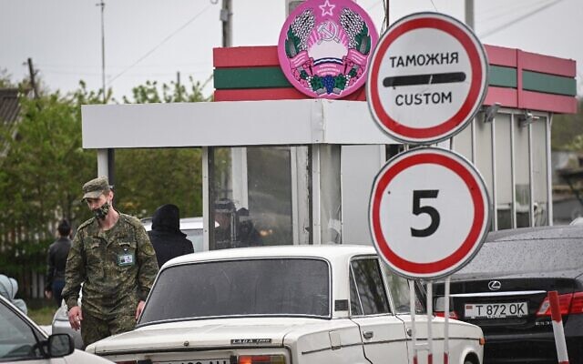 A Transnistrian serviceman watches cars entering the self-proclaimed "Moldovan Republic of Transnistria" at the Varnita crossing with Moldova on April 28, 2022.  (Daniel Mihailescu/AFP)