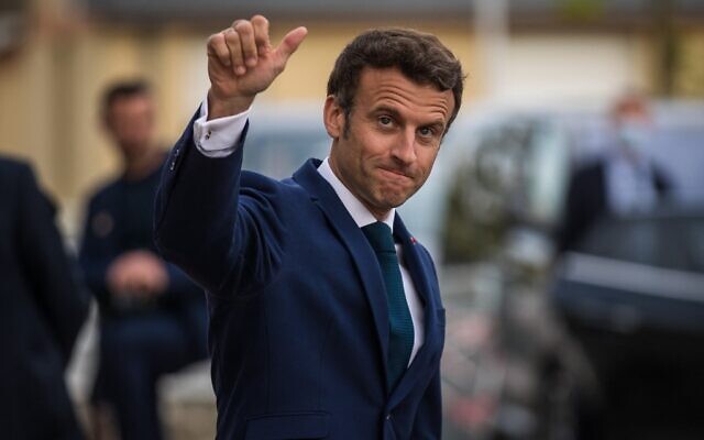 French President Emmanuel Macron gestures as he leaves Percy military hospital after visiting soldiers injured during external operations and caregivers, in Clamart, near Paris, France, on April 28, 2022. (Christophe Petit Tesson/Pool/AFP)