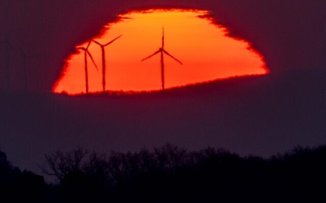 Wind turbines stand in front of the rising sun in Frankfurt, Germany, March 11, 2022. (AP/Michael Probst, File)