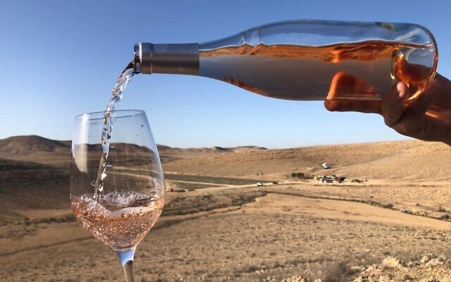 Pouring a Nana Estate Winery rose while looking out toward the unlikely desert terroir of this Negev vineyard. (courtesy, Nana Winery)