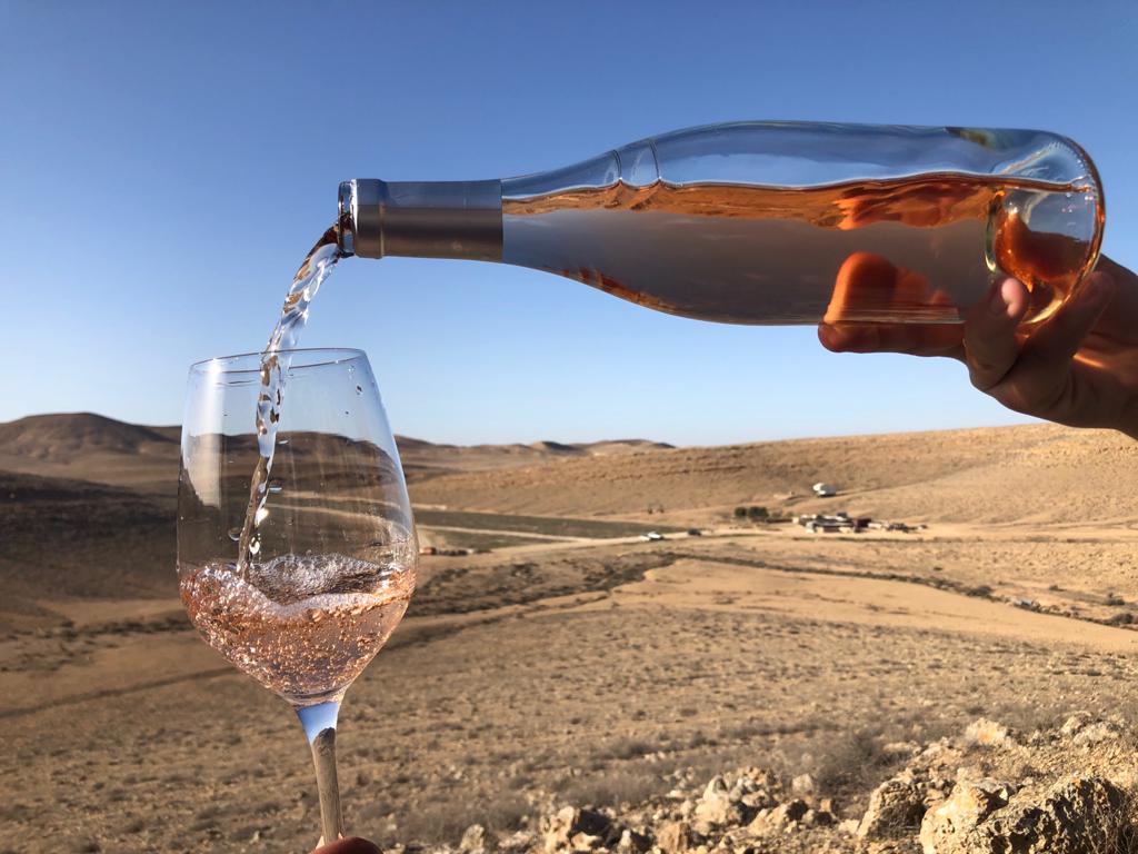 Pouring a Nana Estate Winery rose while looking out toward the unlikely desert terroir of this Negev vineyard. (Courtesy: Nana Winery)