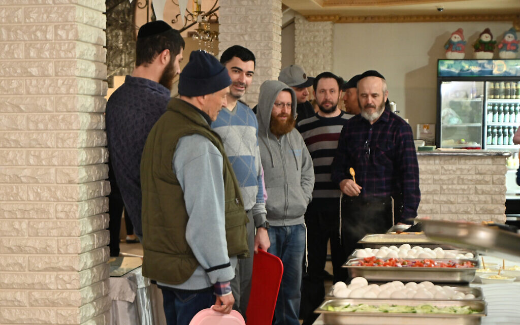 Jewish men wait for breakfast at the refugee camp in Irshava, Ukraine, April 5, 2022. (Cnaan Liphshiz/ JTA)