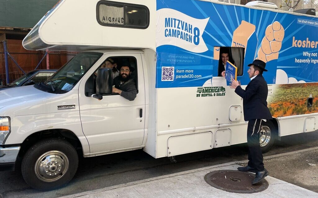A rabbi and his students from Oholei Torah in Crown Heights, Brooklyn prepare to hand out shmura matzah to passersby near Lincoln Center in Manhattan, April 12, 2022. (Jackie Hajdenberg via JTA)