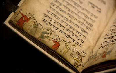 In this photo taken April 20, 2016, the famed Birds' Head Haggadah, a medieval copy of a text read around the Passover holiday table, is seen on display at the Israel Museum in Jerusalem. (AP Photo/Sebastian Scheiner)