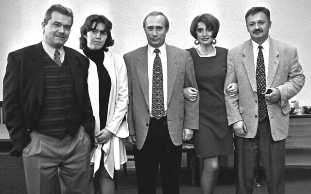 Vladimir Putin, then Russian president Boris Yeltsin’s deputy chief of staff, center, poses with his friends at a party in St.Petersburg, in this February, 1997 file photo. (AP Photo/Dmitri Lovetsky, File)