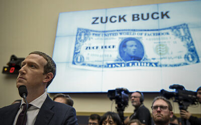 FILE - Facebook Chief Executive Officer Mark Zuckerberg, left, testifies before the House Financial Services Committee on Capitol Hill in Washington, about his plans for the new cryptocurrency Libra, October 23, 2019. (AP Photo/Susan Walsh, File)
