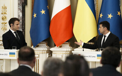 Ukrainian President Volodymyr Zelensky, right, gestures towards French President Emmanuel Macron during a joint press conference February 8, 2022, in Kyiv, Ukraine. (AP Photo/Thibault Camus, Pool)