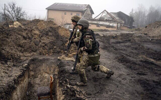 Ukrainian soldiers inspect trenches used by Russian soldiers during the occupation of villages on the outskirts of Kyiv, Ukraine, April 1, 2022. (AP Photo/Rodrigo Abd)