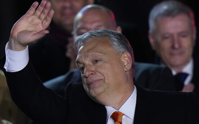 Hungary's Prime Minister Viktor Orban greets cheering supporters during an election night rally in Budapest, Hungary, Sunday, April 3, 2022. (AP Photo/Petr David Josek)