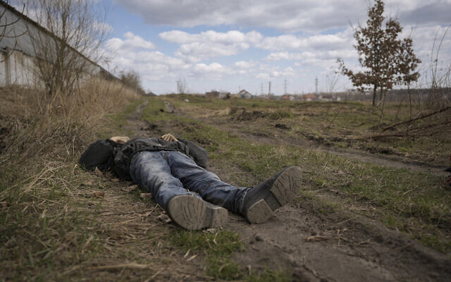 The lifeless body of a man lies on a dirt path in Bucha, Ukraine, April 4, 2022. (AP Photo/ Vadim Ghirda)