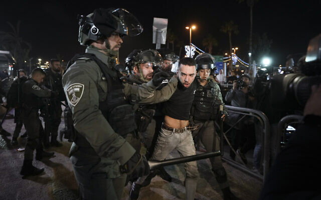 Israeli border police officers detain a protester during clashes between Israeli security forces and Palestinians next to Damascus Gate, outside the Old City of Jerusalem, during the Muslim holy month of Ramadan, Monday, April 4, 2022. (AP Photo/Mahmoud Illean)
