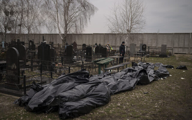 Dozens of bodies wait to be buried at a cemetery in Bucha, outskirts of Kyiv, Ukraine, on April 5, 2022. (AP Photo/Felipe Dana)