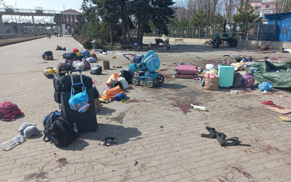 In this photo published on Ukrainian President Volodymyr Zelensky's Telegram channel, blood stains are seen among bags and a baby carriage on a platform after Russian shelling at the railway station in Kramatorsk, Ukraine, Friday, April 8, 2022. (Ukrainian President Volodymyr Zelenskyy's Telegram channel via AP)