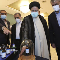 Iranian President Ebrahim Raisi, second right, receives an explanation while visiting an exhibition of Iran's nuclear achievements in Tehran, Iran, April 9, 2022. (Photo released by Iranian Presidency Office via AP)