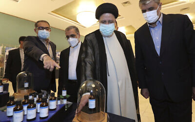 In this photo released by the official website of the office of the Iranian Presidency, President Ebrahim Raisi, second right, receives an explanation while visiting an exhibition of Iran's nuclear achievements in Tehran, Iran, on Saturday, April 9, 2022. (Iranian Presidency Office via AP)