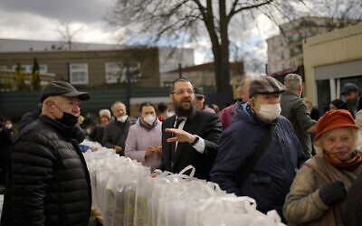 Rabbi Yehuda Teichtal, center, gives instructions during preparations for the celebration of Jewish Passover at the Chabad Jewish Education Center in Berlin, Germany, April 7, 2022. Rabbis and Jewish organizations are working round the clock within Ukraine, Eastern Europe and other parts of Europe to make sure that Jews who remain in Ukraine and refugees who have fled as far away as Israel are able to celebrate Passover. (AP Photo/Markus Schreiber)