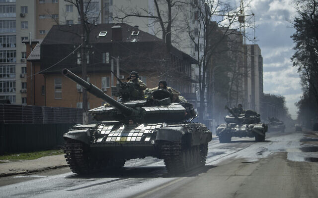 Ukrainian tanks move down a street in Irpin, on the outskirts of Kyiv, Ukraine, Monday, April 11, 2022. (AP Photo/Evgeniy Maloletka)