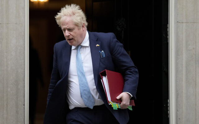 Britain's Prime Minister Boris Johnson leaves 10 Downing Street to attend the weekly Prime Ministers' Questions session in parliament in London, on March 30, 2022. (AP Photo/Frank Augstein)