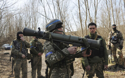 Ukrainian servicemen study a Sweden shoulder-launched weapon system Carl Gustaf M4 during a training session on the near Kharkiv, Ukraine, on April 7, 2022. (AP Photo/Andrew Marienko, File)
