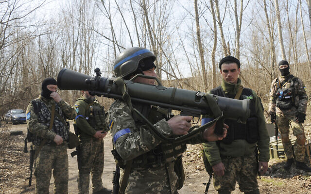 Ukrainian servicemen study a Sweden shoulder-launched weapon system Carl Gustaf M4 during a training session on the near Kharkiv, Ukraine, on April 7, 2022. (AP Photo/Andrew Marienko)
