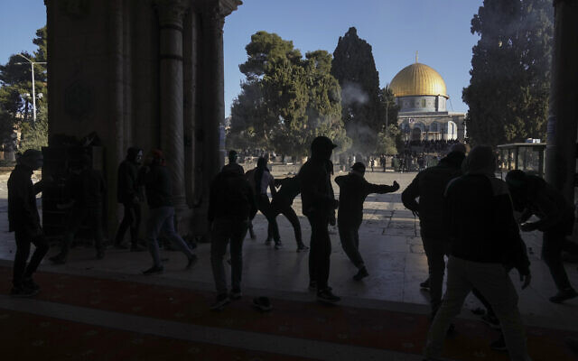 Palestinians clash with Israeli security forces at the Al-Aqsa Mosque compound atop the Temple Mount in Jerusalem's Old City Friday, April 15, 2022. (AP Photo/Mahmoud Illean)