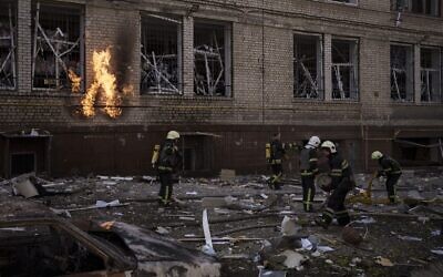 Firefighters work to extinguish multiple fires after a Russian attack in Kharkiv, Ukraine, on April 16, 2022. (AP Photo/Felipe Dana)
