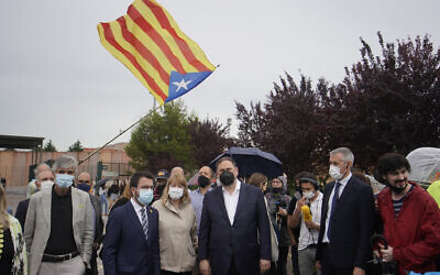 Former deputy president of the Catalan regional government Oriol Junqueras, center, walks with the current Catalonian president Pere Aragones, 2nd left, in front of an 'estelada' or Catalan pro-independence flag after being released from the Lledoners prison in Sant Joan de Vilatorrada near Barcelona, Spain, June 23, 2021. (AP Photo/ Joan Mateu, File)