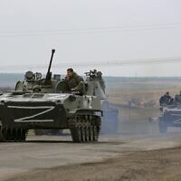 Russian military vehicles move on a highway in an area controlled by Russian-backed separatist forces near Mariupol, Ukraine, on April 18, 2022. (AP Photo/Alexei Alexandrov)