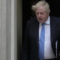 Britain's Prime Minister Boris Johnson leaves 10 Downing Street for the House of Commons to make a statement about Downing Street parties during the coronavirus lockdowns in London, on April 19, 2022. (AP Photo/Alastair Grant)