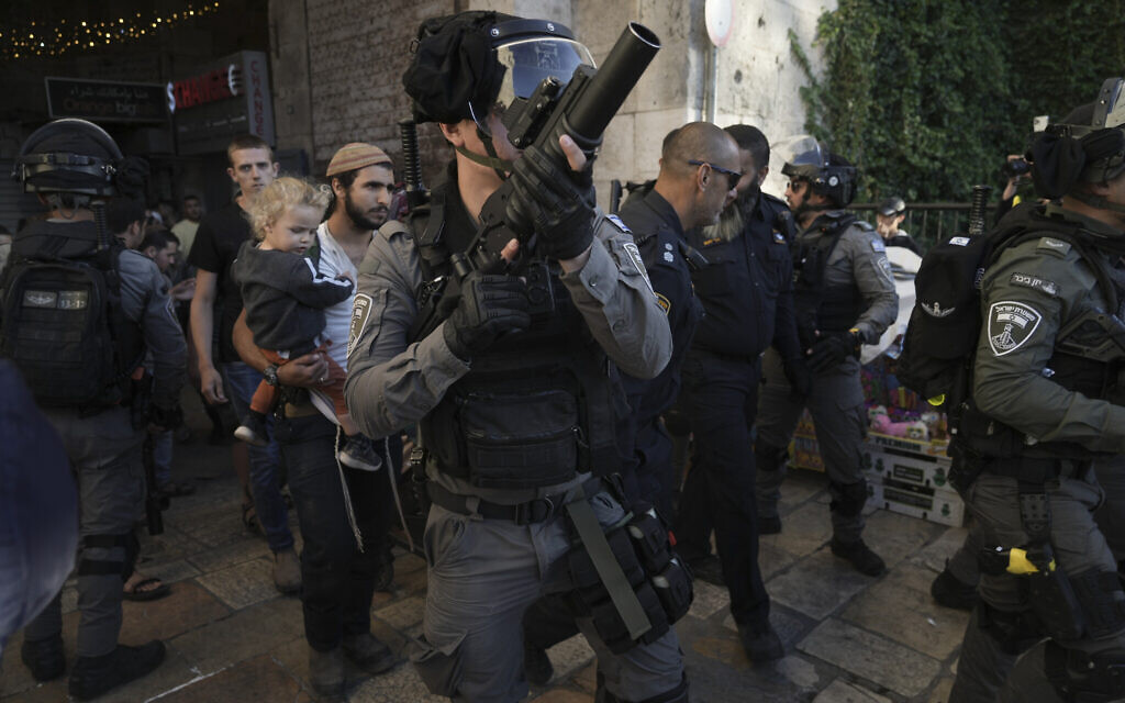 Israeli security forces escort a group of Jews outside Damascus Gate, in Jerusalem's Old City, Wednesday, April 20, 2022. (AP/Mahmoud Illean)