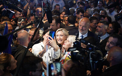 French far-right leader Marine Le Pen mobbed by supporters during a campaign rally in Perpignan, southern France, April 7, 2022. (AP Photo/Joan Mateu Parra)