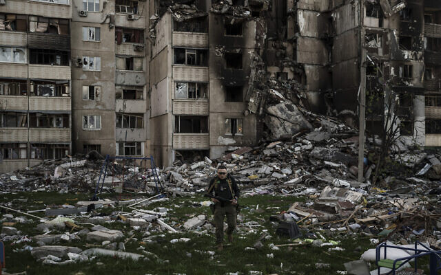 A Ukrainian serviceman walks amid the rubble of a building heavily damaged by multiple Russian bombardments near a frontline in Kharkiv, Ukraine, on April 25, 2022. (AP Photo/Felipe Dana)