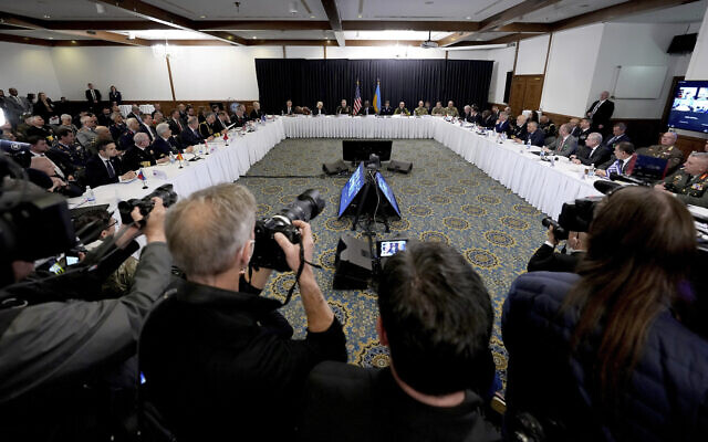 US Secretary of Defense, Lloyd Austin, rear center, delivers a speech as he hosts the meeting of the Ukraine Security Consultative Group at Ramstein Air Base in Ramstein, Germany, on April 26, 2022. (AP Photo/Michael Probst)