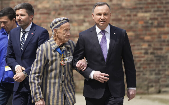 Poland's President Andrzej Duda, right, and Auschwitz Survivor from US Edward Mosberg, attend the March of the Living annual observance that was not held for two years due to the global COVID-19 pandemic, in Oswiecim, Poland, on April 28, 2022. (AP Photo/Czarek Sokolowski)