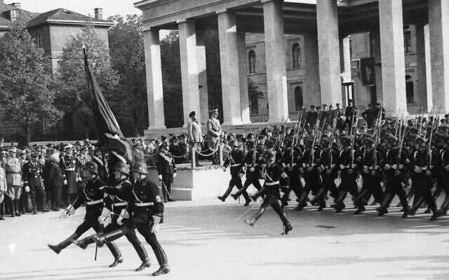 Italy's Benito Mussolini and Germany's Adolf Hitler review troops on parade, Sept. 26, 1937. (AP Photo)