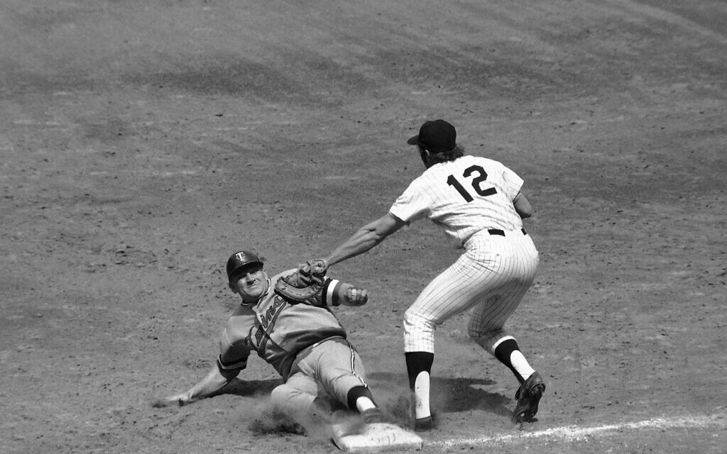 Minnesota Twins' Harmon Killebrew slides safely back to first base, beating up a pick-off attempt by New York Yankee's Ron Blomberg (12). (AP Photo/Harry Harris)