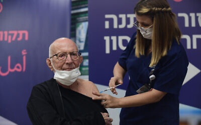 A heart transplant patient receives a fourth dose of the COVID-19 vaccine, at the Sheba Medical Center on December 31, 2021. (Tomer Neuberg/Flash90)