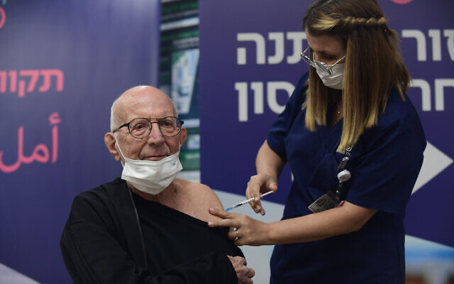 A heart transplant patient receives a fourth dose of the COVID-19 vaccine, at the Sheba Medical Center on December 31, 2021. (Tomer Neuberg/Flash90)