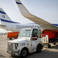 Workers load packages of Israeli humanitarian aid for Ukraine onto El Al aircraft, at Ben Gurion airport in Tel Aviv, on March 1, 2022. (Avshalom Sassoni‎‏/Flash90)