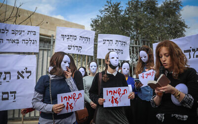 Haredi women and girls protest against sexual assault in their community outside a school in Ramat Shlomo, March 7, 2022. (Yonatan Sindel/Flash90)