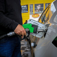 A man fills up his car at a gas station in Jerusalem, March 11, 2022. (Jamal Awad/Flash90)