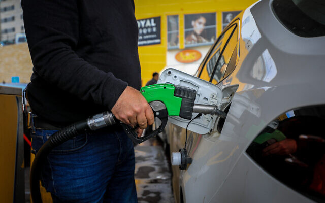 Illustrative image of a man filling up his car at a gas station, in Jerusalem, on March 11, 2022 (Jamal Awad/Flash90)