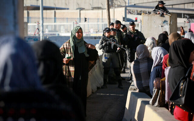 Palestinian women cross the Qalandiya checkpoint, outside of the West bank city of Ramallah, on April 15, 2022. (Flash90)