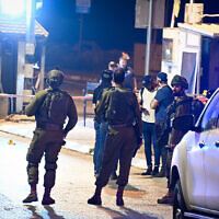 Israeli security personnel at the scene of a shooting attack, at the entrance to Ariel, in the West Bank, on April 30, 2022 (Flash90)