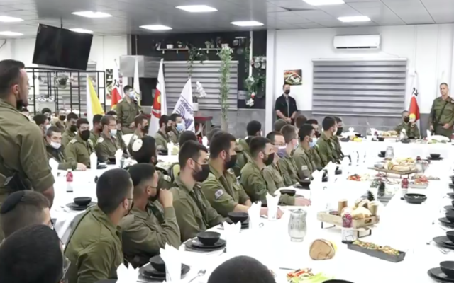 IDF Chief of Staff Aviv Kohavi (right) listens as a soldier addresses him at the Ofer military base in the West Bank on April 7, 2022. (Screen capture/ Channel 12)