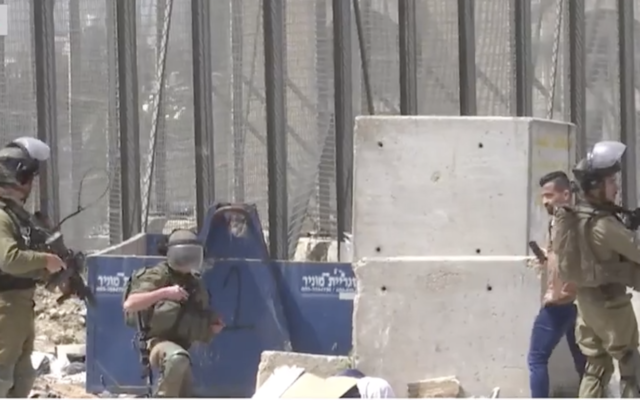 Israeli troops filmed in the aftermath of a shooting incident in Husan in which a Palestinian woman was killed on Sunday, April 10, 2022 (Screenshot/Palestine TV)