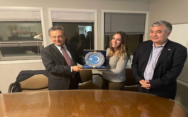 Teich (center) receiving a gift of appreciation from the World Ugyhur Congress president Dolun Isa (left) and Uyghur Rights Advocacy project Executive Direct Mehmet Tohti (right)